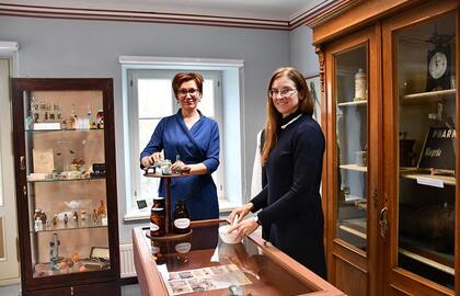 Į tikėjimų prietarais, keisčiausių preparatų laikus nukeliančios Šilutės Hugo Šojaus muziejaus parodos „Senosios vaistinės“ kuratorės Natalija Kučinskaja (kairėje) ir Asta Bartkevičiūtė.